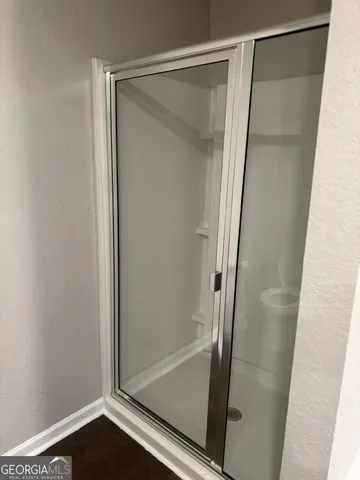 a bathroom with a glass shower door