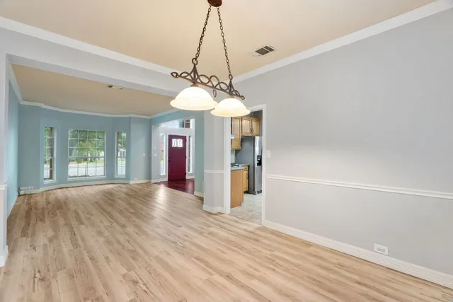 a view of a livingroom with a furniture wooden floor and window