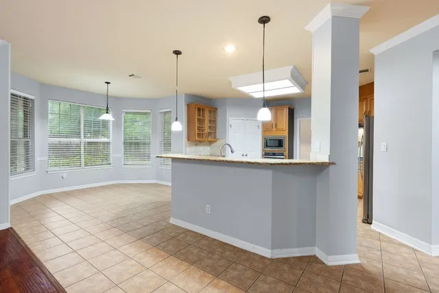 a view of a kitchen with a window and chandelier