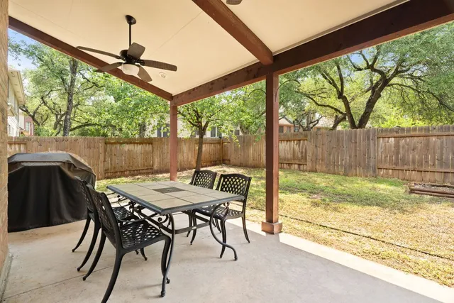 a view of a patio with a table chairs and a backyard