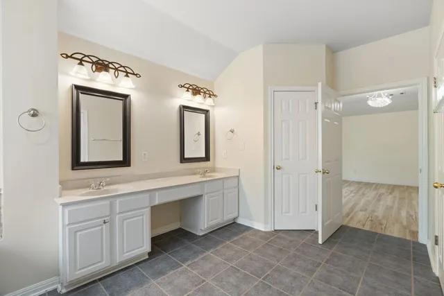 a bathroom with a double vanity sink mirror and