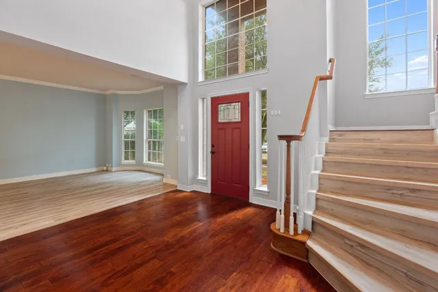 a view of an entryway with wooden floor and door