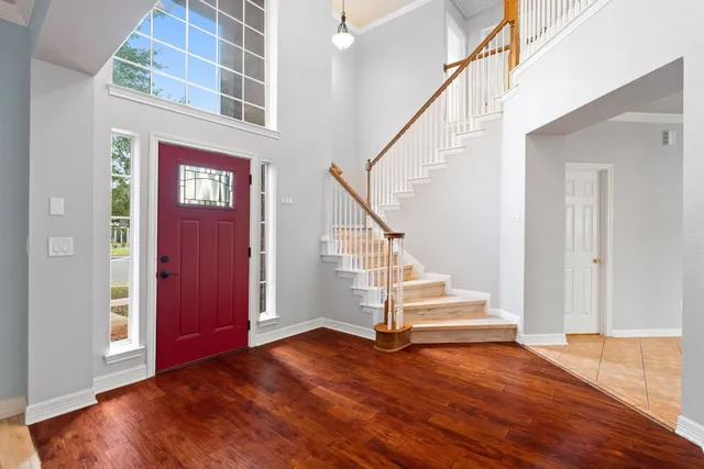 a view of entryway and hall with wooden floor