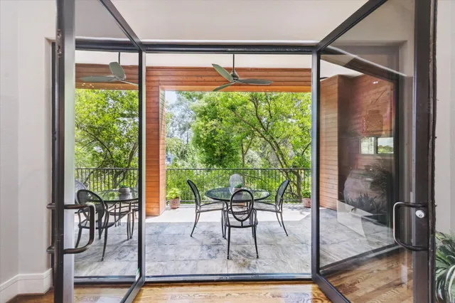 a dining room with glass windows and glass table