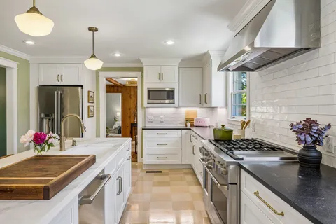 a kitchen with a sink stove and refrigerator