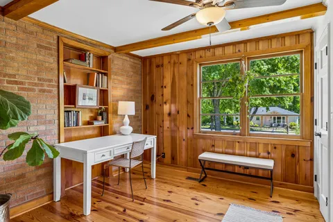 a reading room with furniture and a window