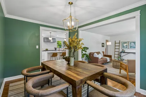 a dining room with furniture and window