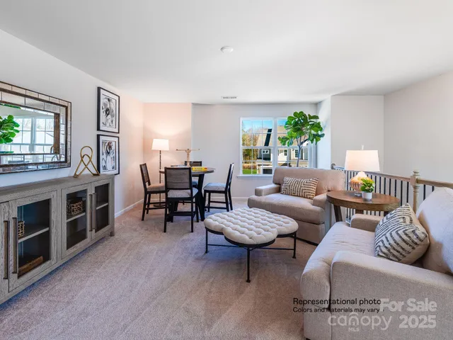 a living room with furniture and a floor to ceiling window