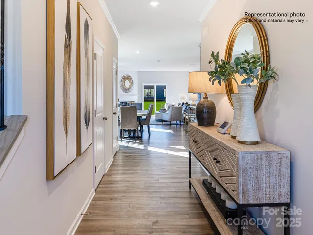 a kitchen with stainless steel appliances granite countertop a stove top oven a sink dishwasher a dining table and chairs with wooden floor