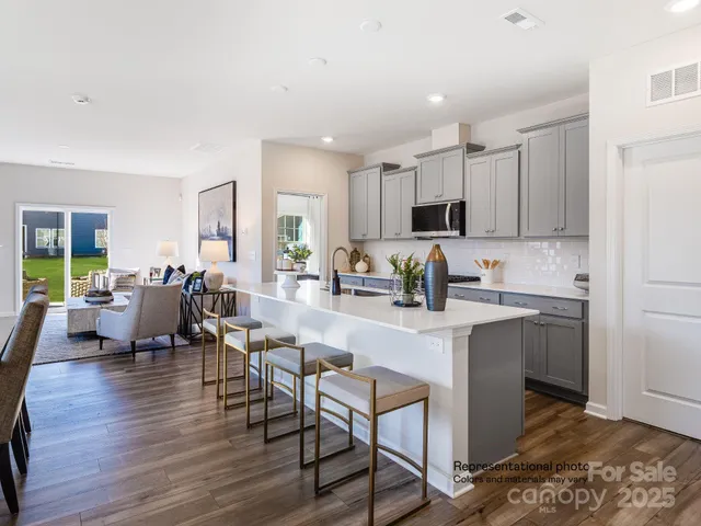 a kitchen with appliances a sink and cabinets