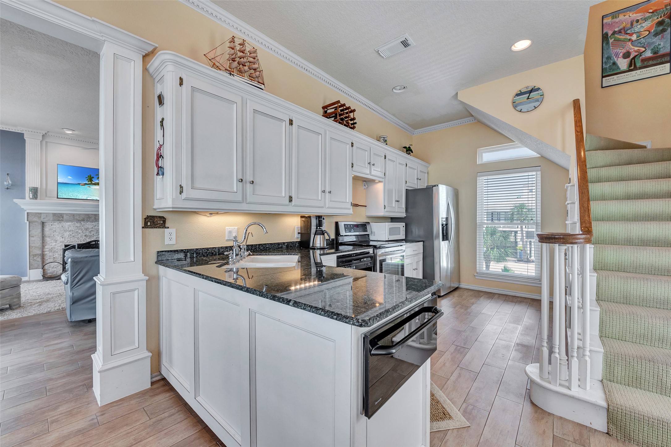 247 Isles End Road Tiki Island, TX 77554 - Photo 12 of 48 a kitchen with stainless steel appliances granite countertop a stove a sink and a refrigerator