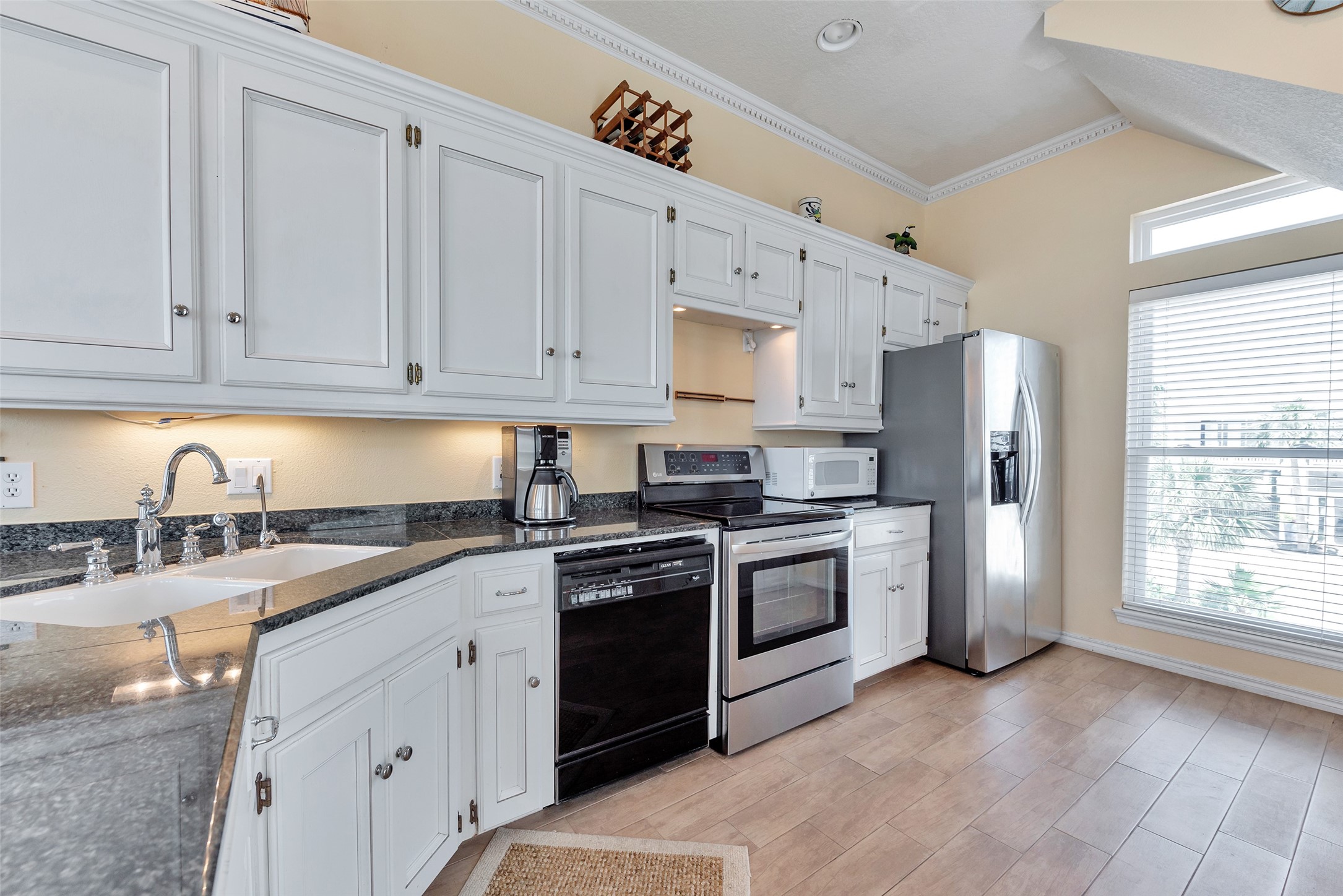 247 Isles End Road Tiki Island, TX 77554 - Photo 13 of 48 a kitchen with stainless steel appliances granite countertop a stove sink and refrigerator