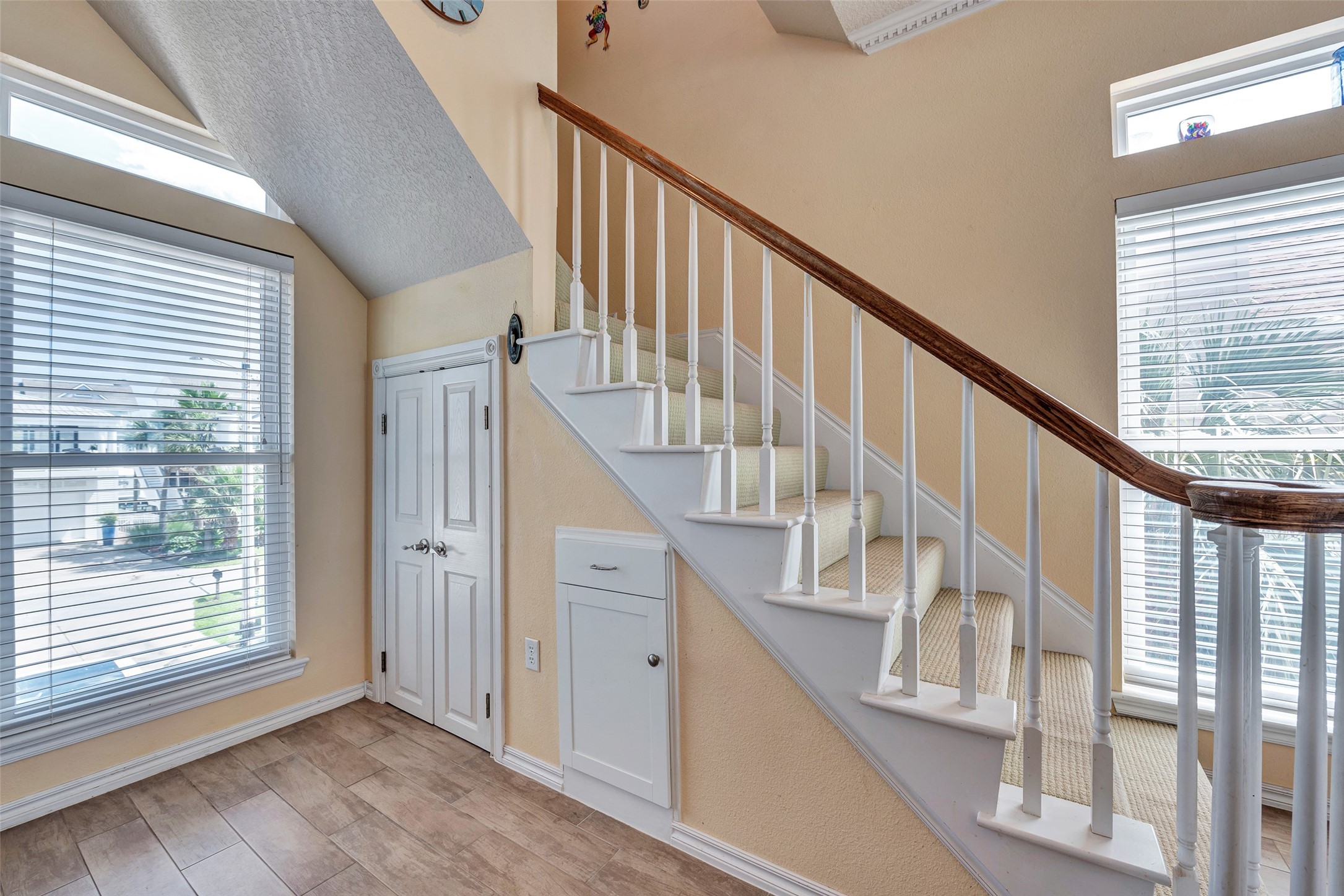 247 Isles End Road Tiki Island, TX 77554 - Photo 14 of 48 Tucked neatly beneath the staircase, the pantry offers clever use of space without sacrificing design. This area adds both charm and functionality to the heart of the home.