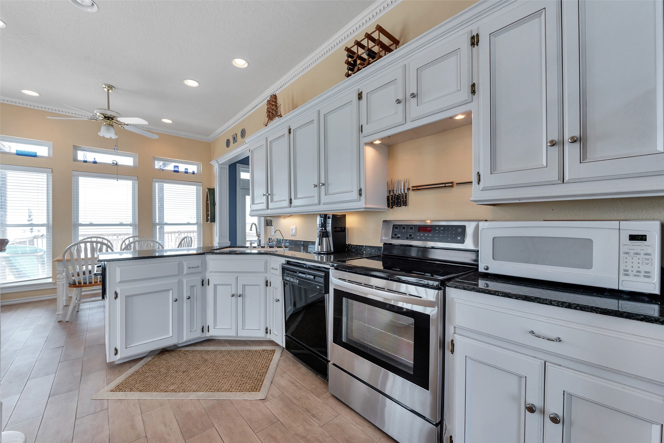 247 Isles End Road Tiki Island, TX 77554 - Photo 15 of 48 a kitchen with cabinets appliances and a wooden floor