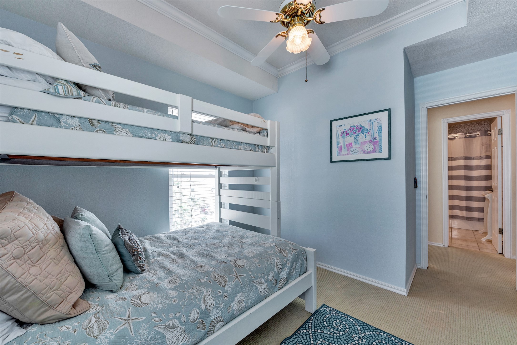 247 Isles End Road Tiki Island, TX 77554 - Photo 18 of 48 a bedroom with a large bed and a chandelier