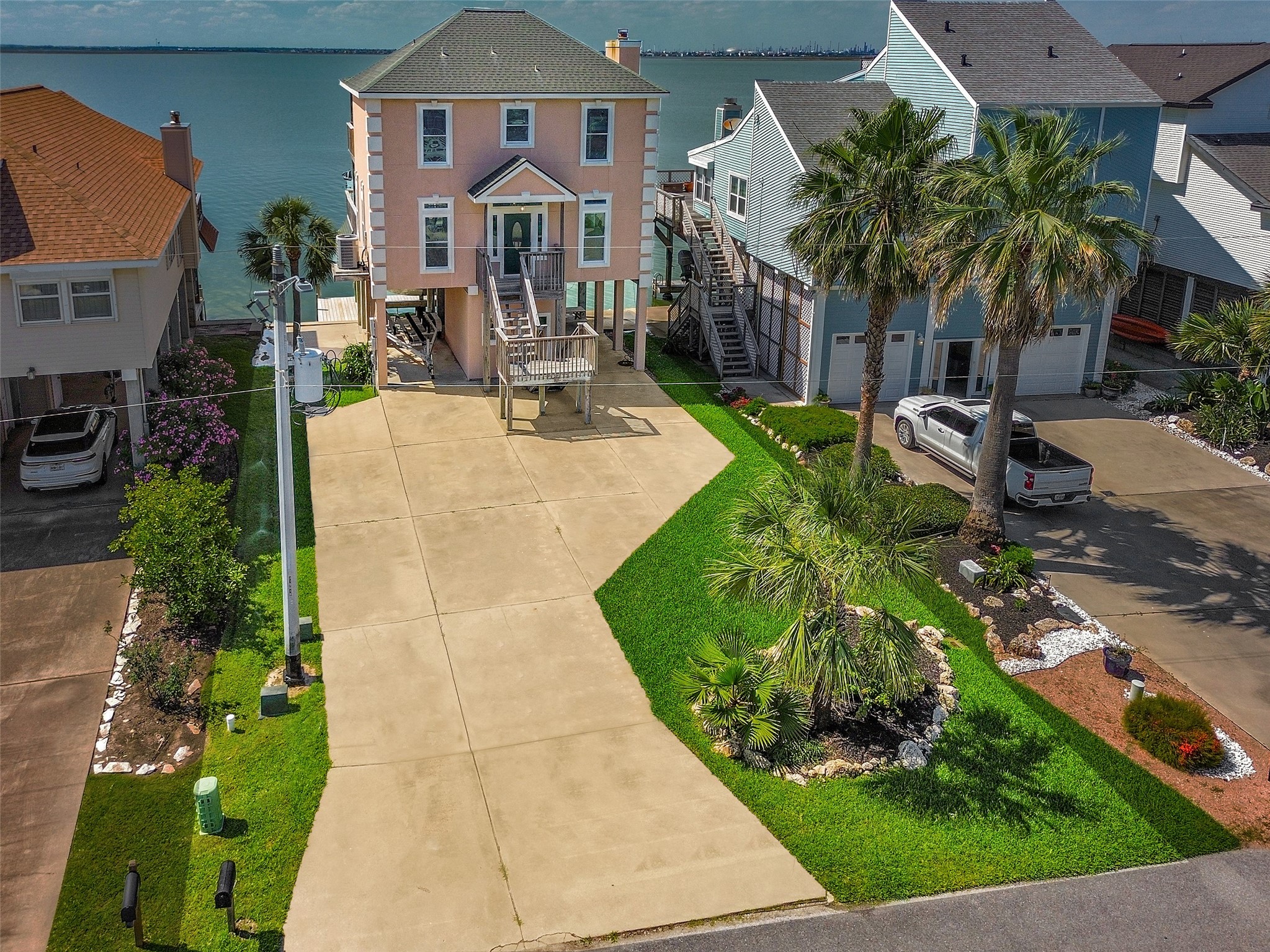247 Isles End Road Tiki Island, TX 77554 - Photo 2 of 48 a front view of a house with a yard