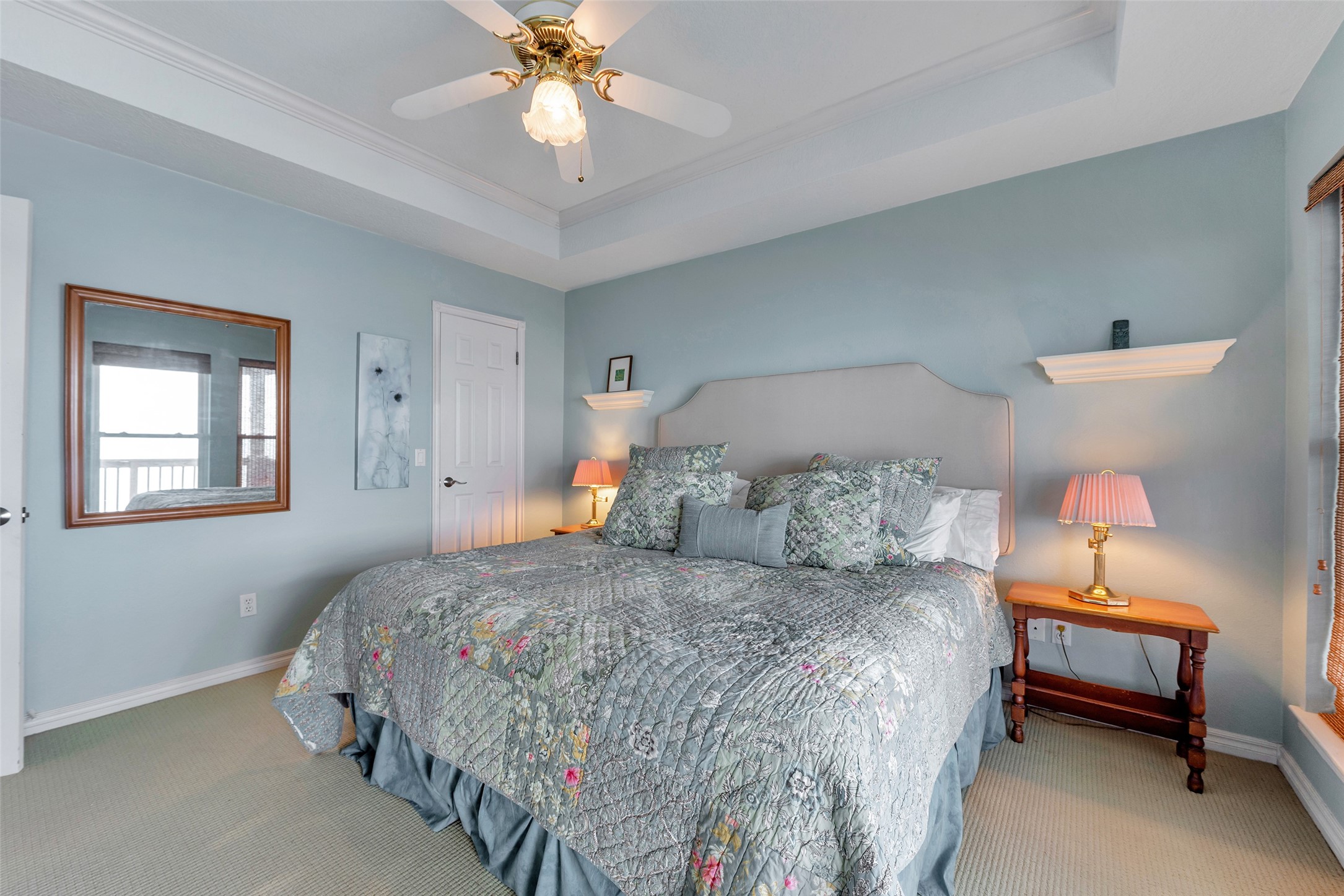 247 Isles End Road Tiki Island, TX 77554 - Photo 23 of 48 a bedroom with a bed and a chandelier