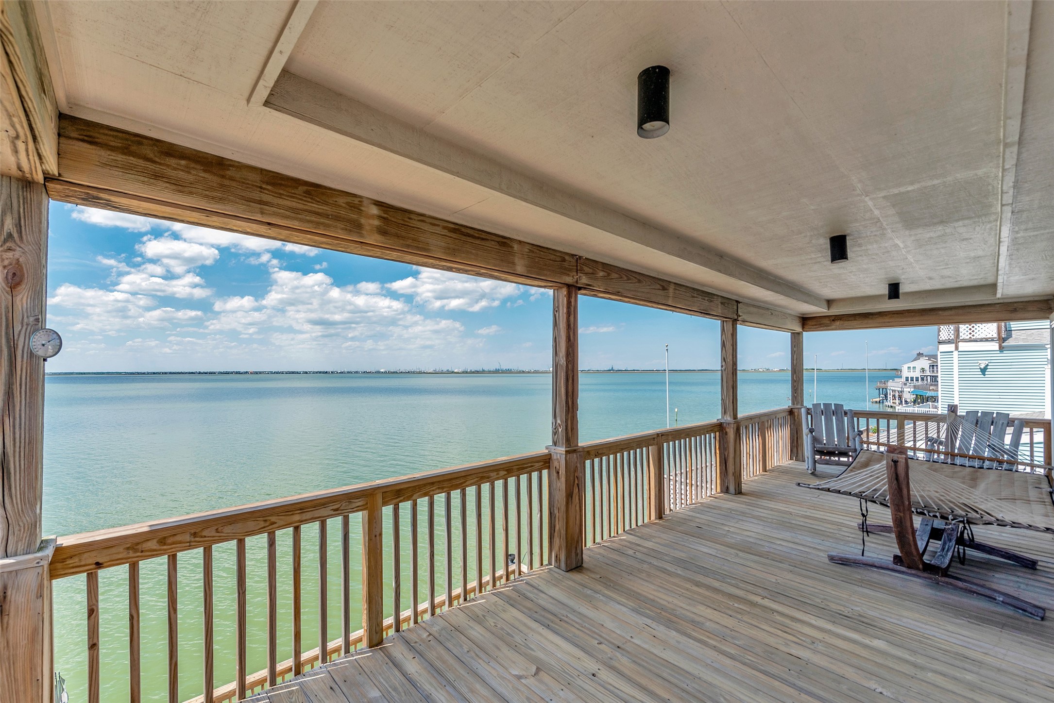 247 Isles End Road Tiki Island, TX 77554 - Photo 27 of 48 Tucked near the end of the island, this upper balcony feels like your own quiet corner of the bay. With no backyard neighbors and wide water views, it’s easy to forget the world and just relax.