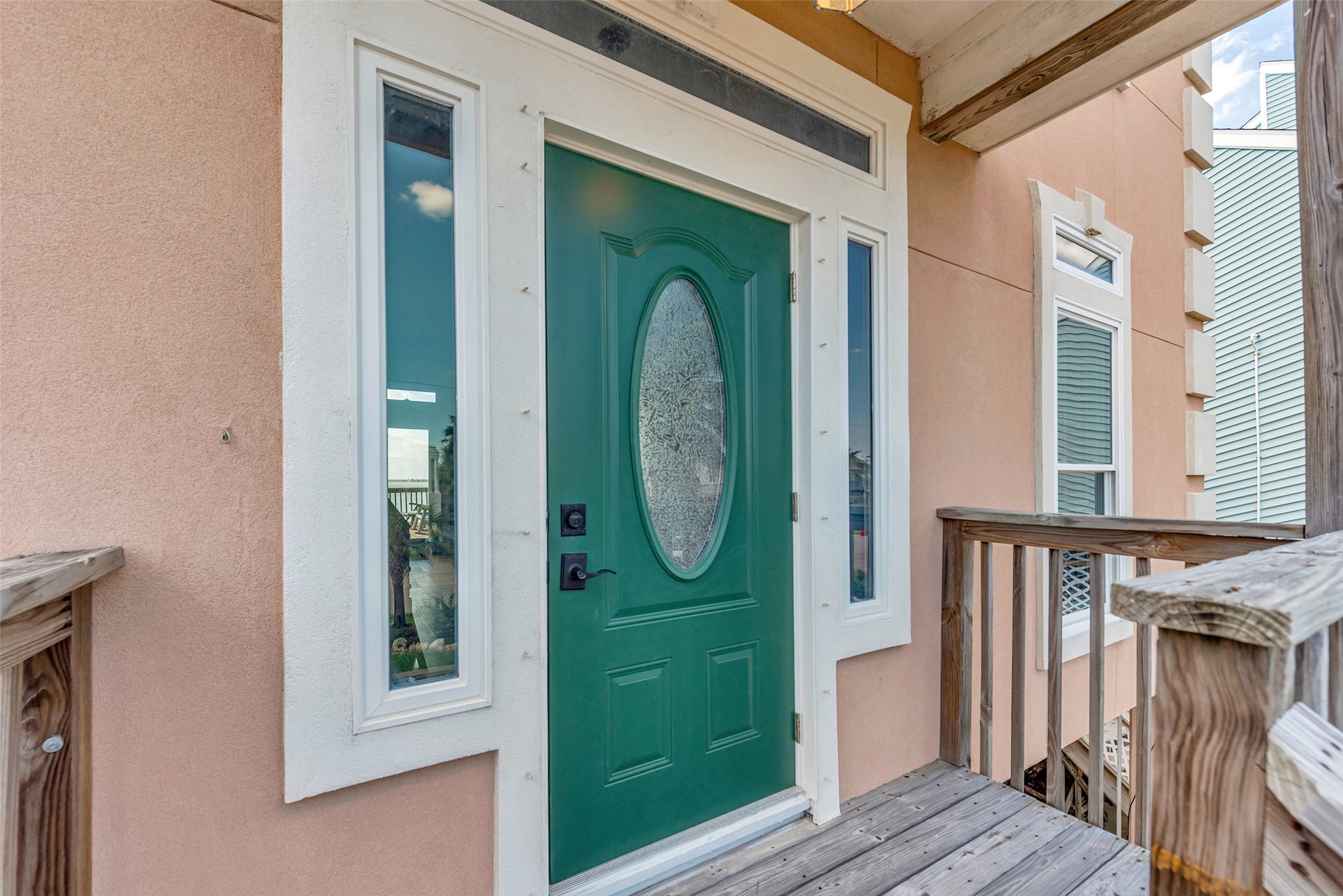 247 Isles End Road Tiki Island, TX 77554 - Photo 3 of 48 Greet guests with charm at the covered front Entry featuring a decorative oval-glass front door framed by sidelights that bring in natural light.