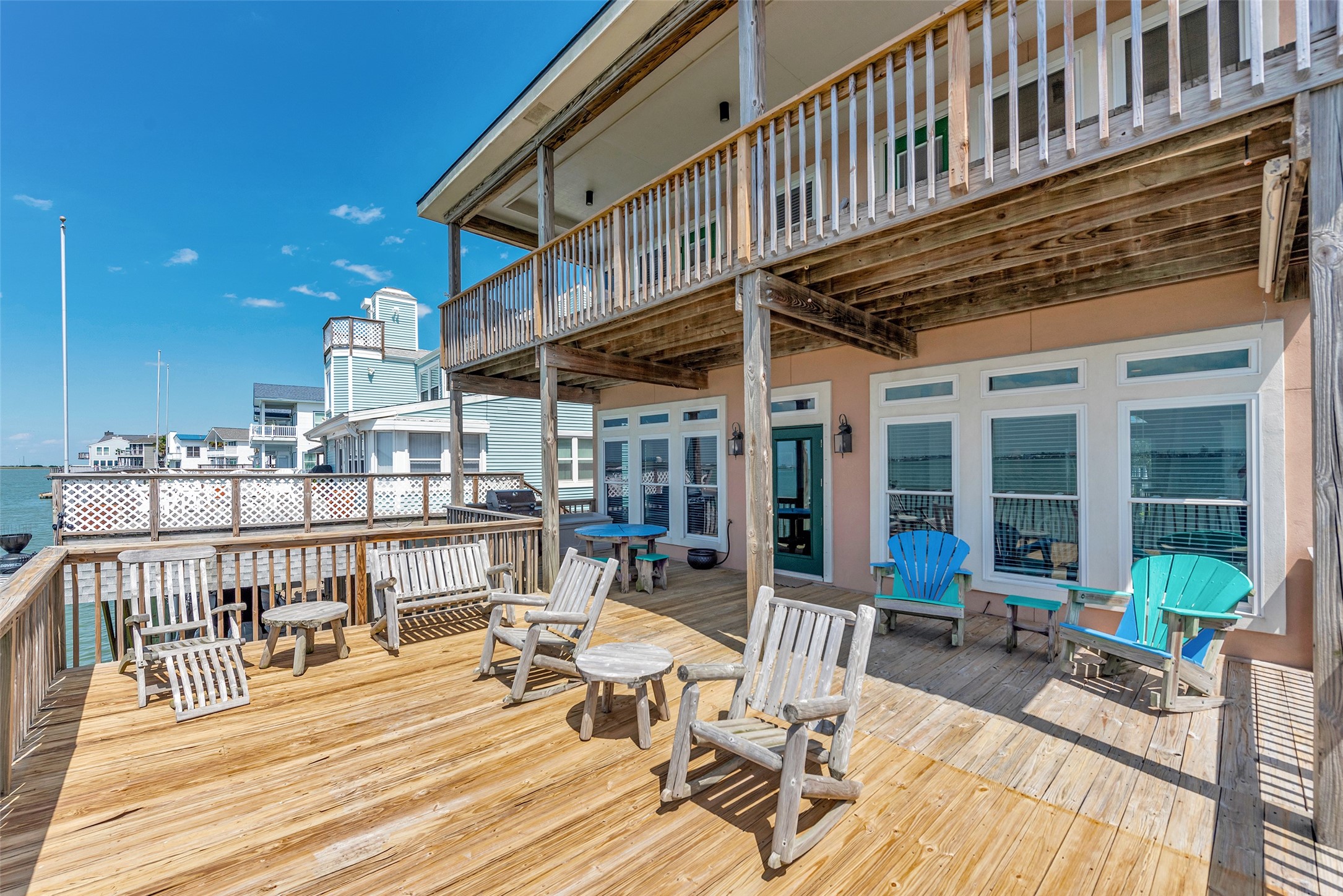 247 Isles End Road Tiki Island, TX 77554 - Photo 37 of 48 a view of a patio with table and chairs and wooden floor