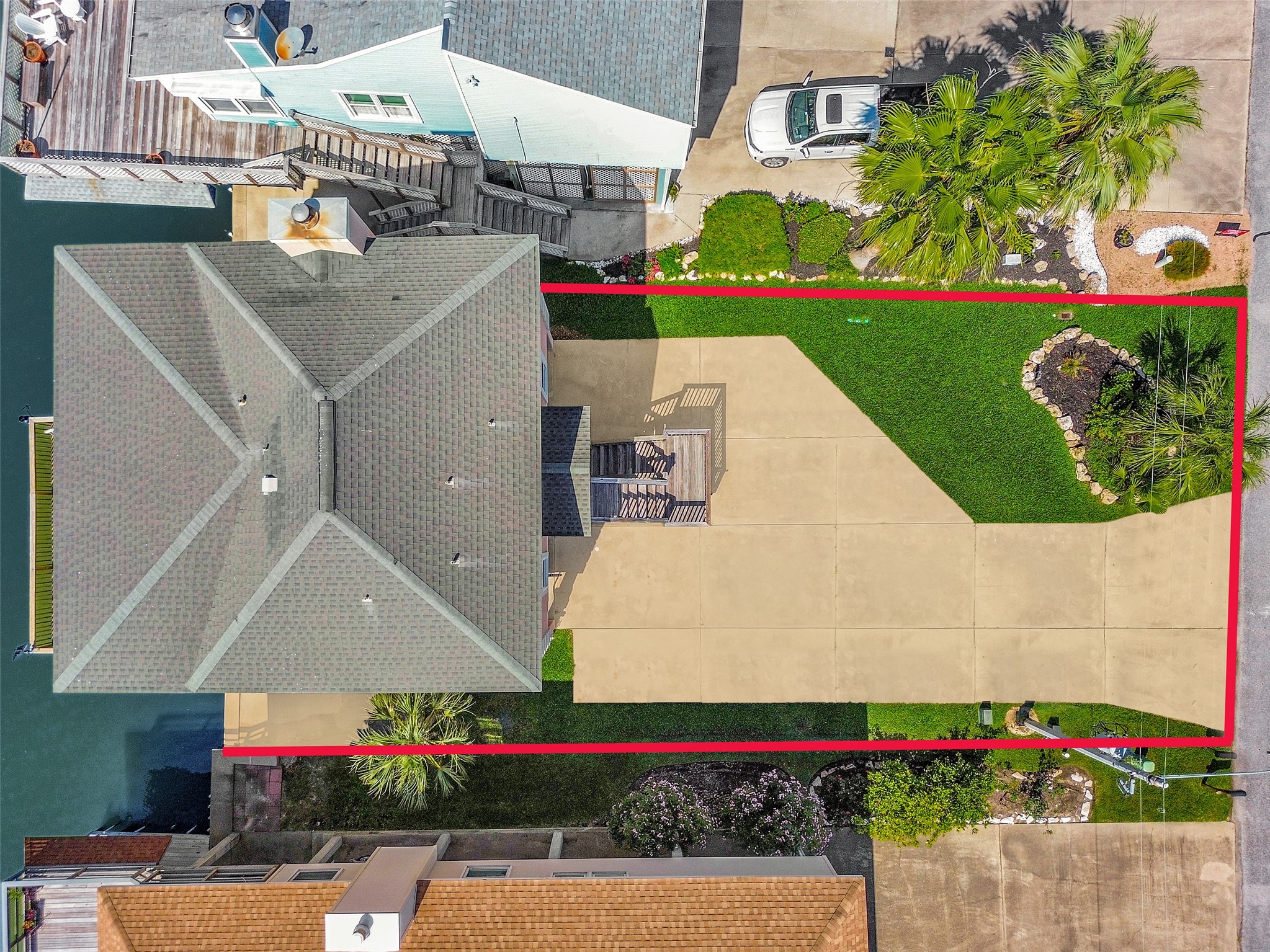 247 Isles End Road Tiki Island, TX 77554 - Photo 42 of 48 Bird’s-eye view of the full lot shows off the home’s footprint, spacious driveway, and beautifully landscaped yard.