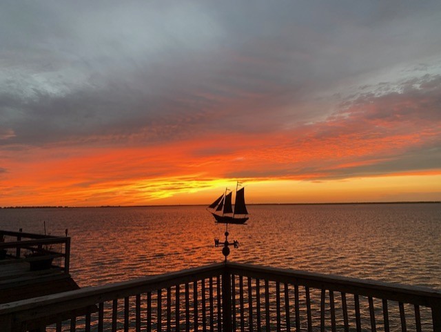 247 Isles End Road Tiki Island, TX 77554 - Photo 48 of 48 The deck becomes your front-row seat to the day’s last light show. As the sun dips below the horizon, the warm tones light up the water — a peaceful scene that’s all yours to enjoy.