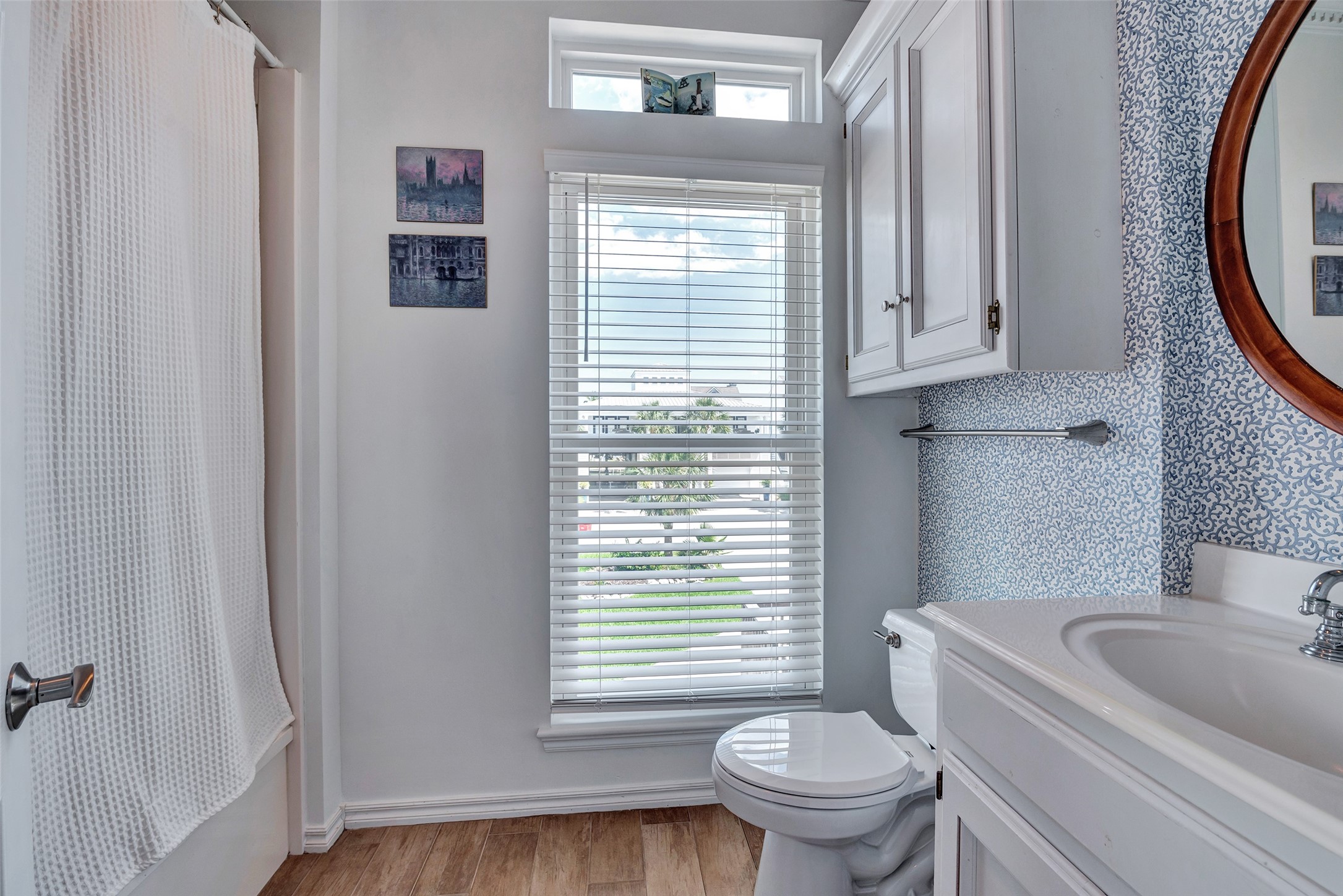 247 Isles End Road Tiki Island, TX 77554 - Photo 9 of 48 a white toilet sitting next to a bathroom sink