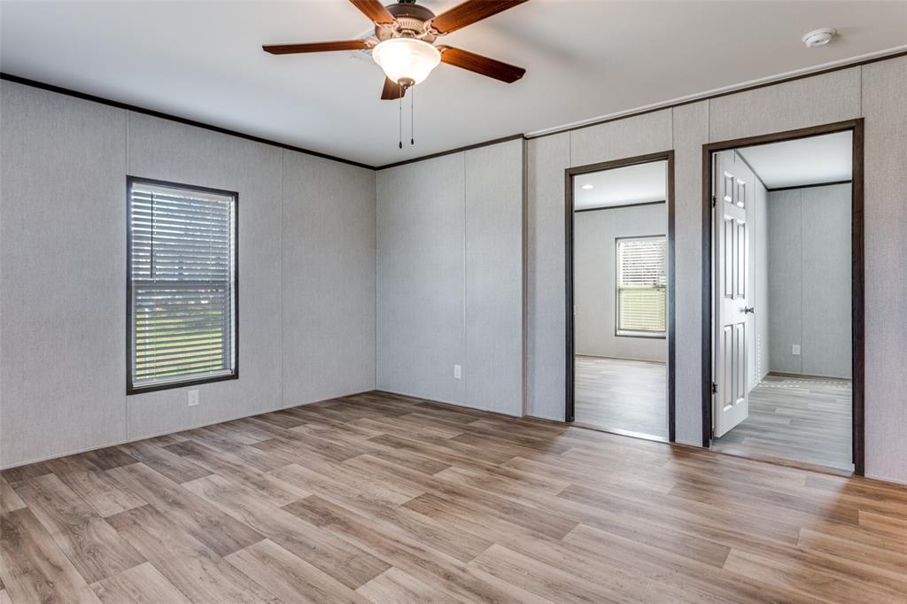 175 Cedar Drive Azle, TX 76020 - Photo 14 of 25 an empty room with wooden floor fan and windows