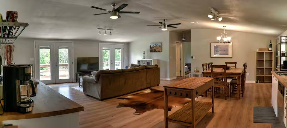 8807 High Valley Road Austin, TX 78737 - Photo 15 of 22 Natural wood flooring complements this generously proportioned living space with outdoor access.