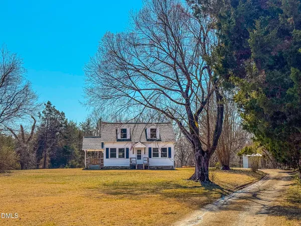 a house that has a tree in front of it