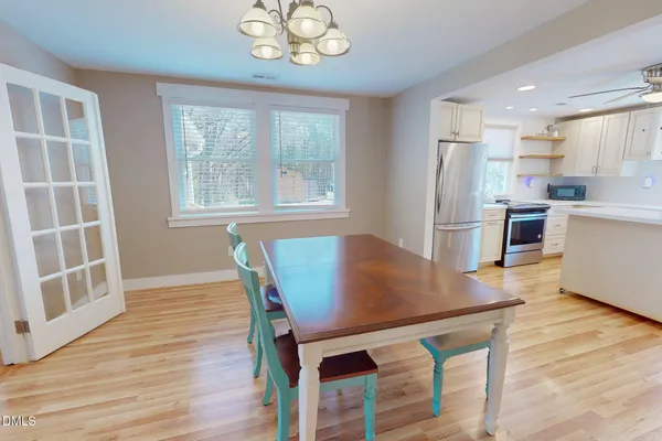 a view of a dining room with furniture and wooden floor