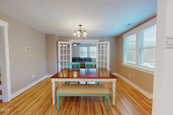a room with wooden floor and pool table