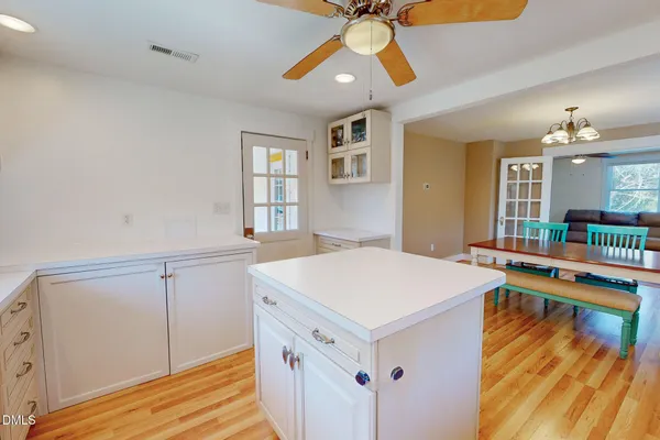a view of a room that has a bed and a chandelier