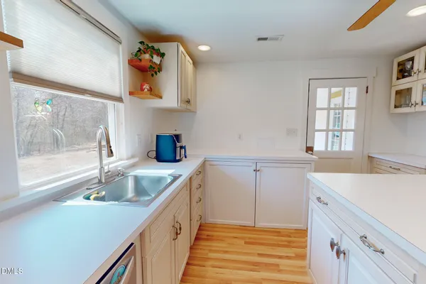 a kitchen with a sink and cabinets