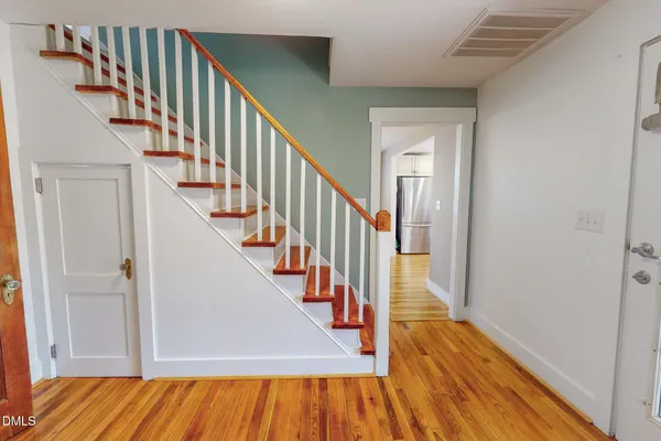 a view of entryway and hall with wooden floor