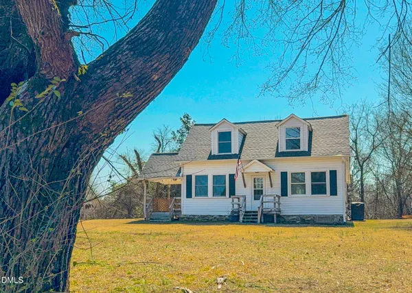 a front view of house with yard and swimming pool
