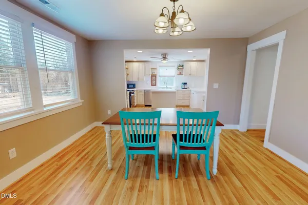 a view of a dining room with furniture wooden floor and a chandelier