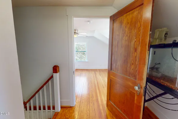 a view of hallway with wooden floor and stairs