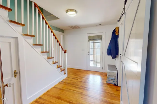 a view of an entryway with wooden floor