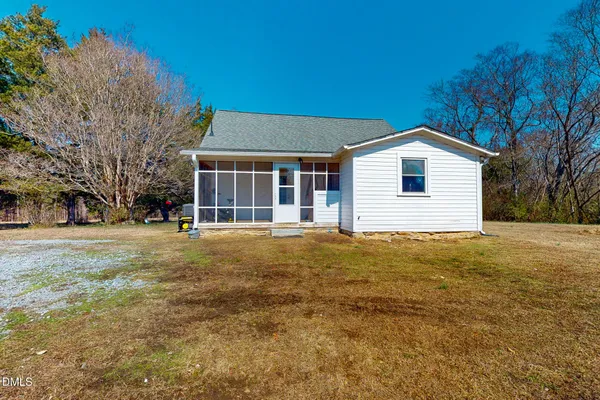 a view of a house with a backyard