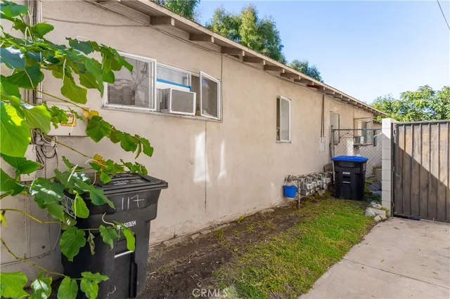 a backyard of a house with table and chairs