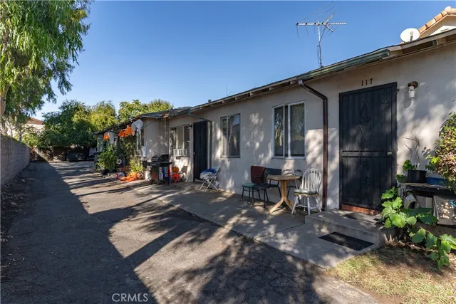 a view of a house with backyard and sitting area