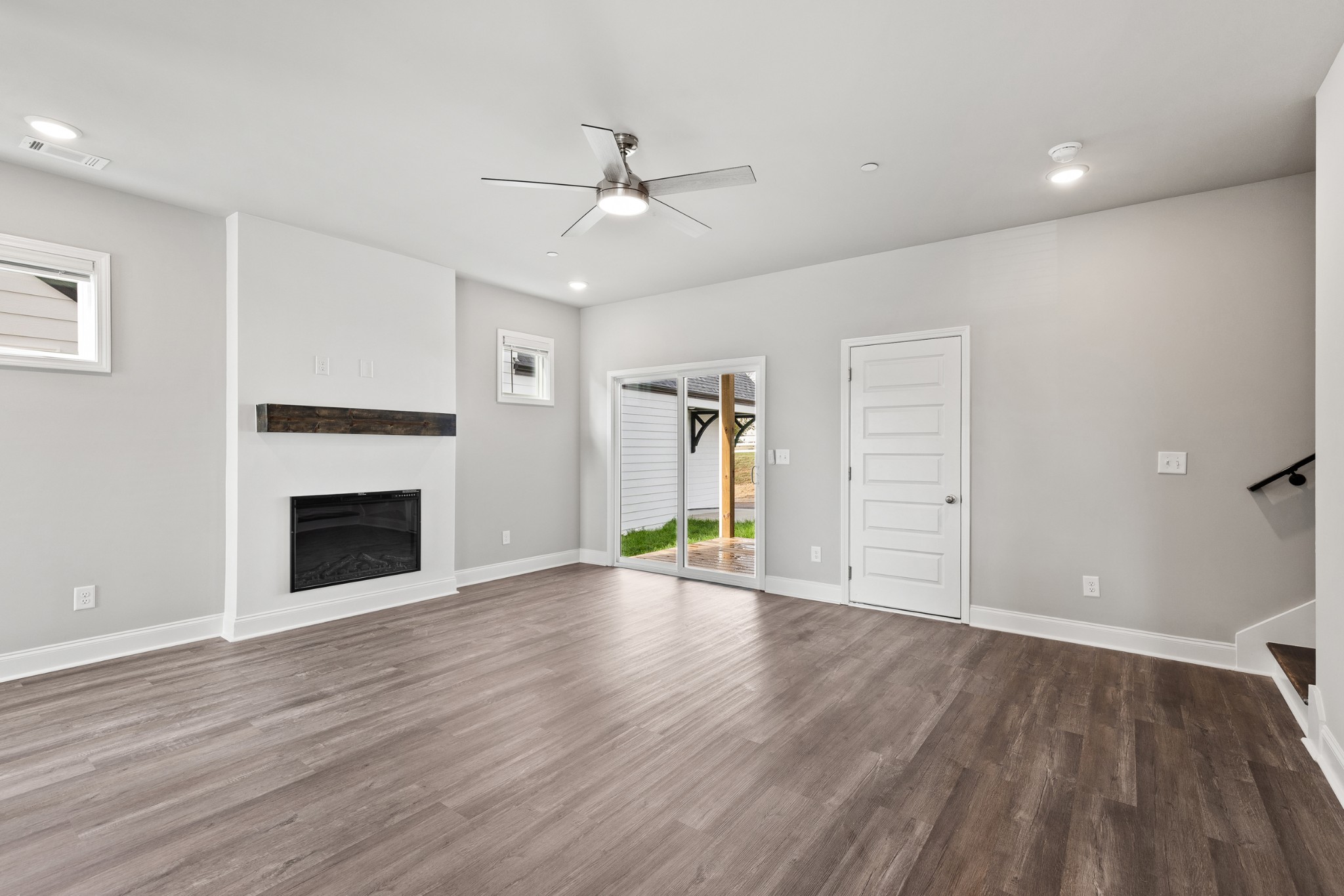 232 Franklin Street Pleasant View, TN 37146 - Photo 11 of 49 an empty room with wooden floor fireplace and windows