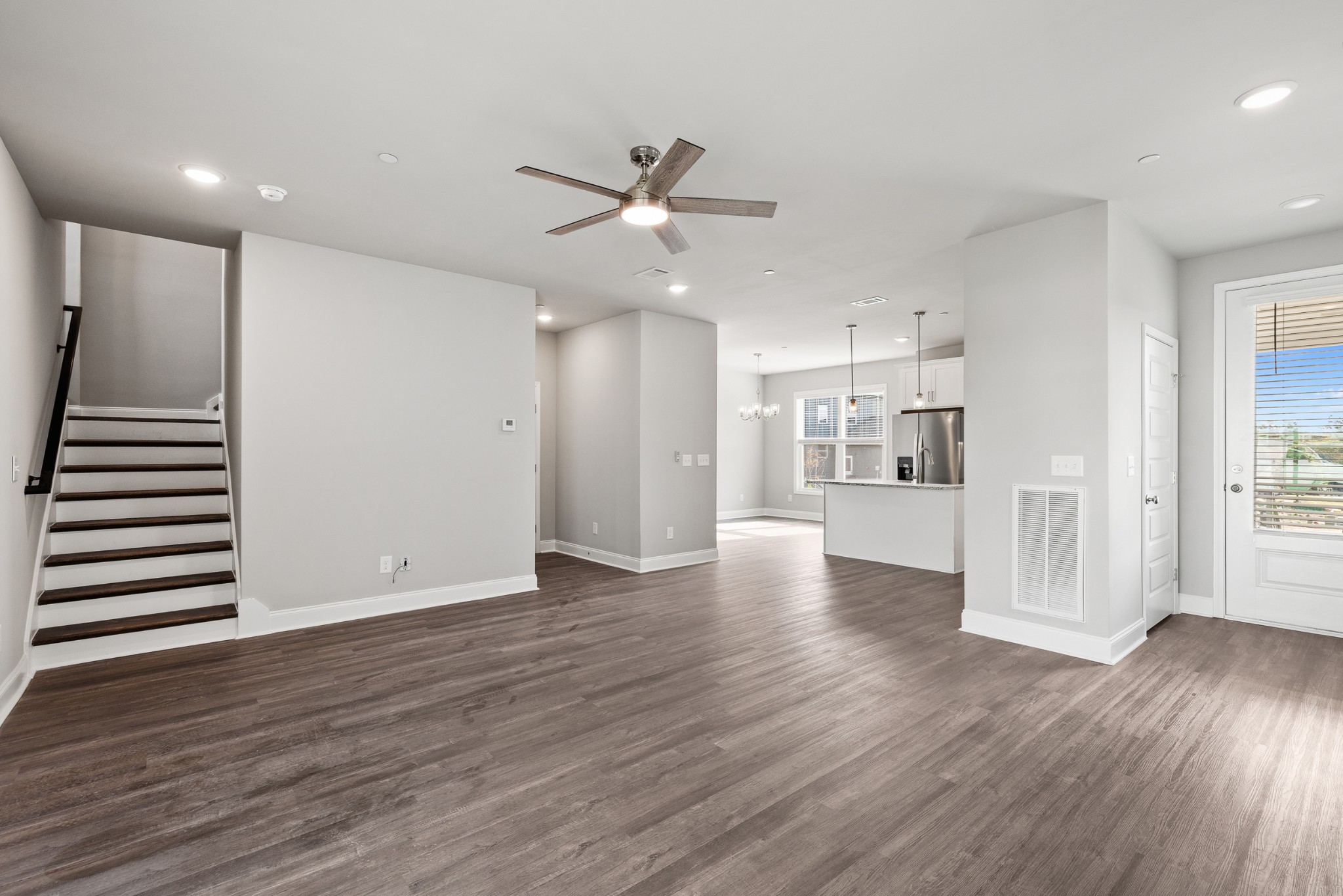 232 Franklin Street Pleasant View, TN 37146 - Photo 13 of 49 a view of an empty room with wooden floor and a kitchen