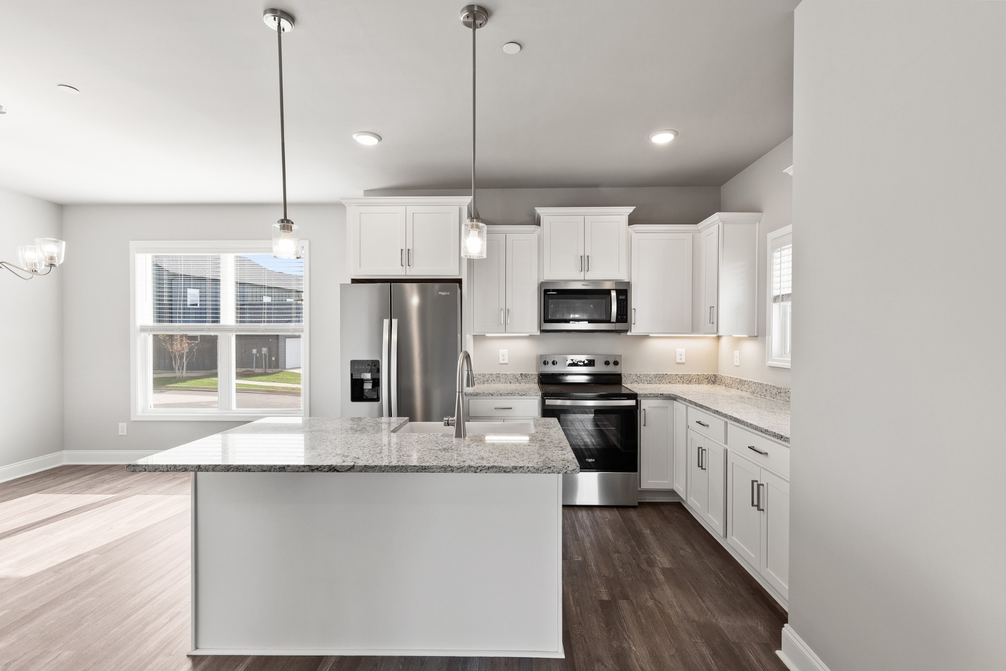 232 Franklin Street Pleasant View, TN 37146 - Photo 14 of 49 a kitchen with stainless steel appliances granite countertop a refrigerator a stove a sink and white cabinets with wooden floor