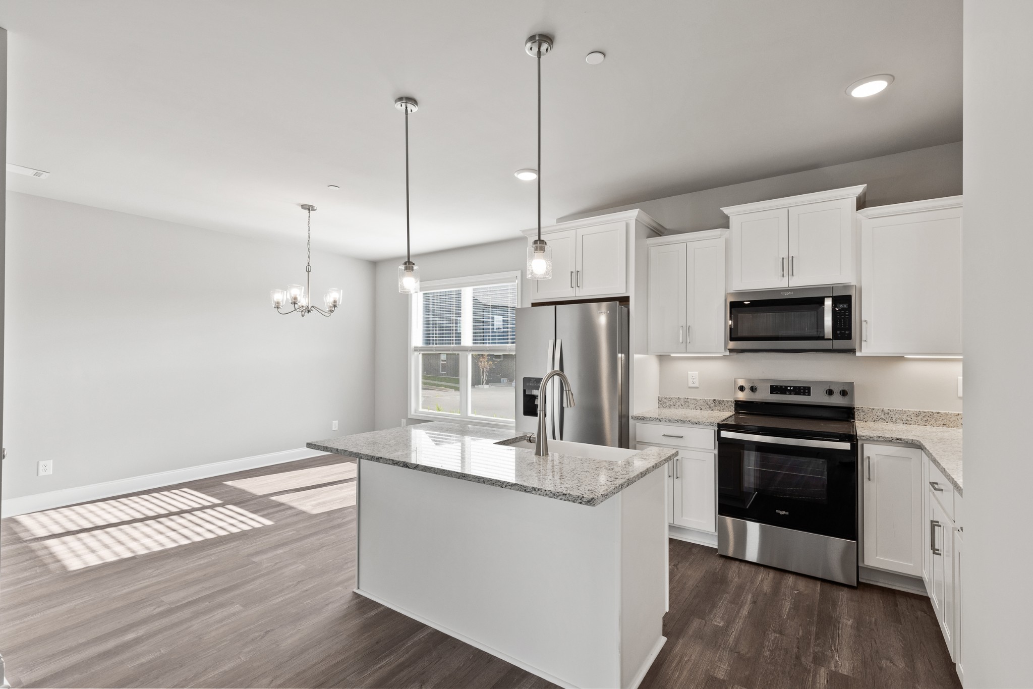 232 Franklin Street Pleasant View, TN 37146 - Photo 15 of 49 a kitchen with stainless steel appliances granite countertop a sink a stove a refrigerator and white cabinets with wooden floor