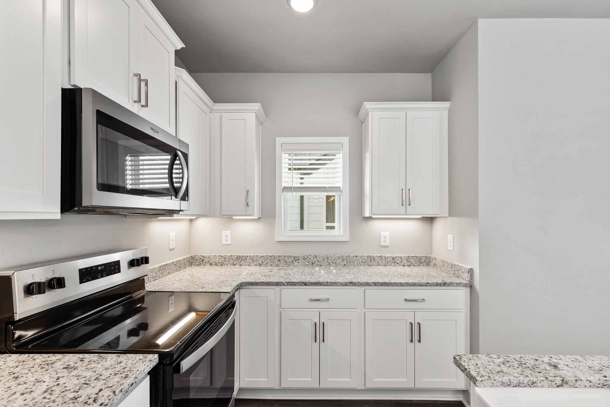 232 Franklin Street Pleasant View, TN 37146 - Photo 17 of 49 a kitchen with granite countertop a stove sink and cabinets