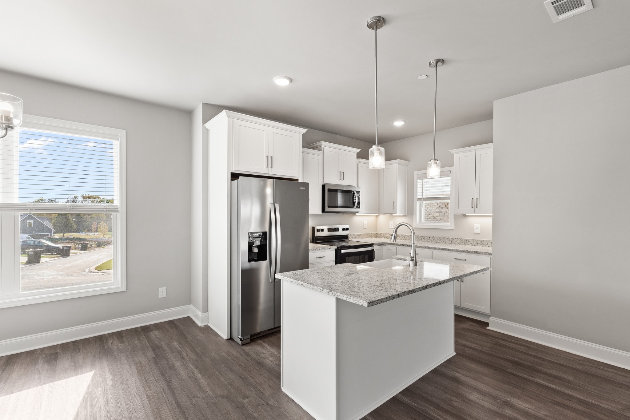 232 Franklin Street Pleasant View, TN 37146 - Photo 19 of 49 a kitchen with stainless steel appliances granite countertop a refrigerator a sink dishwasher a stove and white countertops with wooden floor