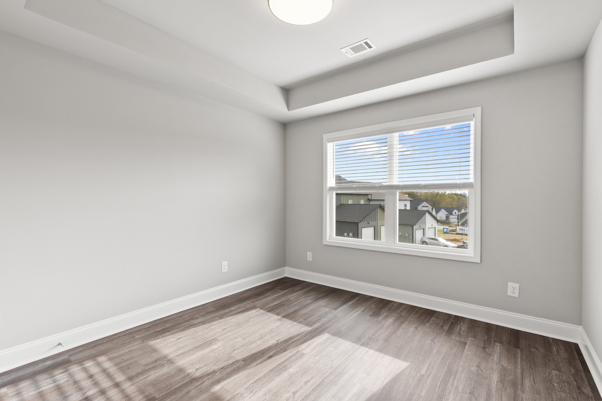 232 Franklin Street Pleasant View, TN 37146 - Photo 32 of 49 an empty room with wooden floor and windows