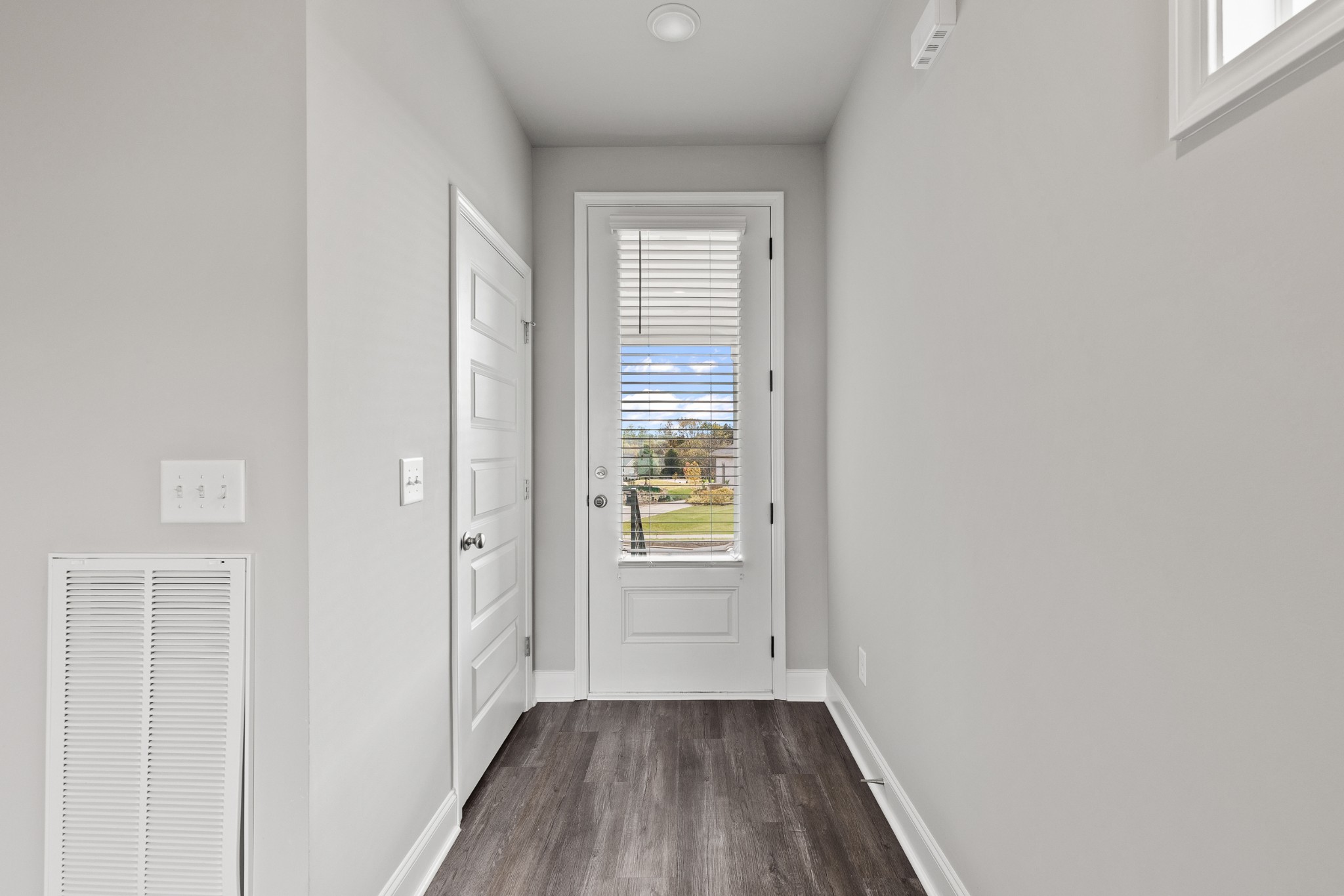 232 Franklin Street Pleasant View, TN 37146 - Photo 9 of 49 a view of an empty room with wooden floor and a window